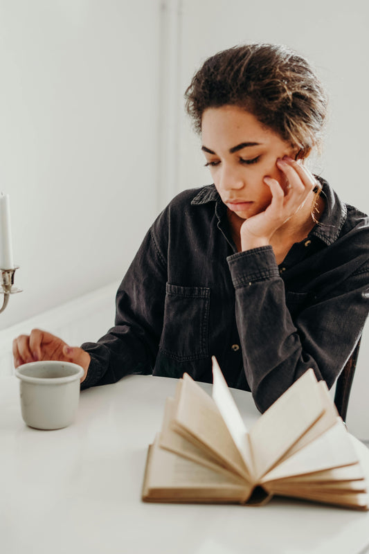 Woman, cup of coffee, book
